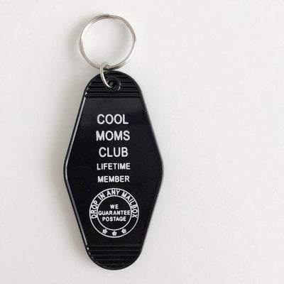 A black, motel-style key tag with a silver keyring. The white text on the tag reads 