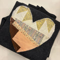 Patchwork heart design on a folded black fabric background