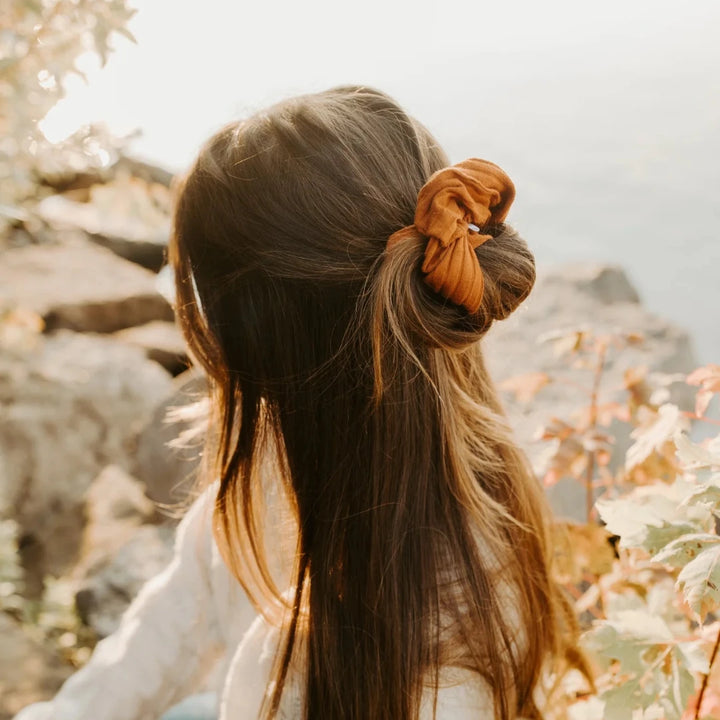 A burnt orange ribbed scrunchie.