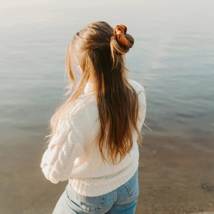 A burnt orange ribbed scrunchie.