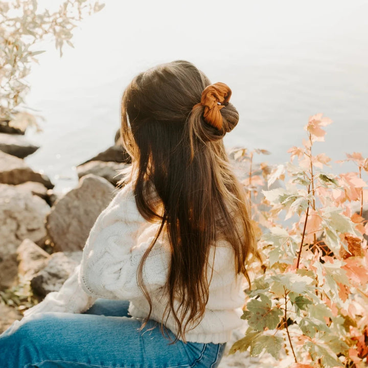A burnt orange ribbed scrunchie.