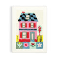 Colorful embroidered house on a white background