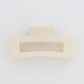 Two beige hair clips on a white background