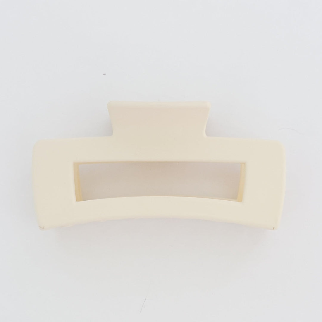 Two beige hair clips on a white background
