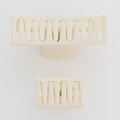 Decorative wall sconces with a geometric design on a white background