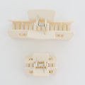 Beige hair clips on a white background