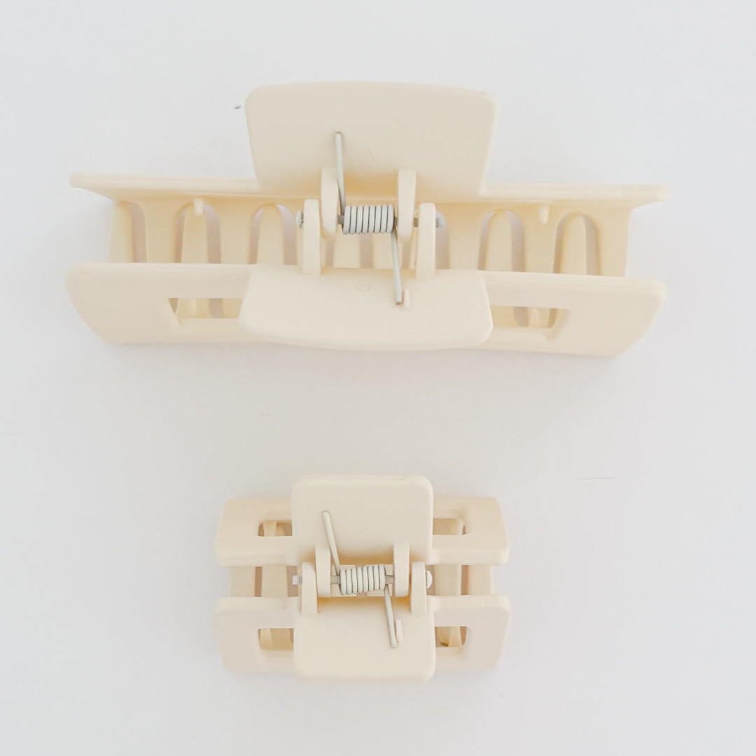 Beige hair clips on a white background