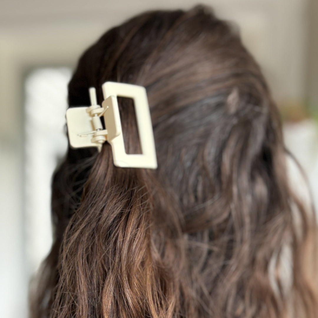Gold hair clip in a person's hair with a blurred background