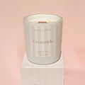 Candle labeled 'Creamsicle' by North Rose on a pink background