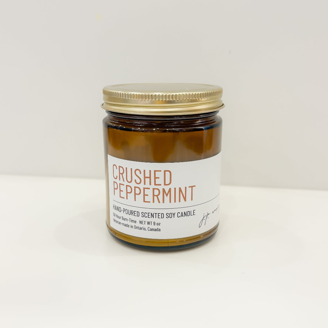 Jar of crushed peppermint candle on a white background