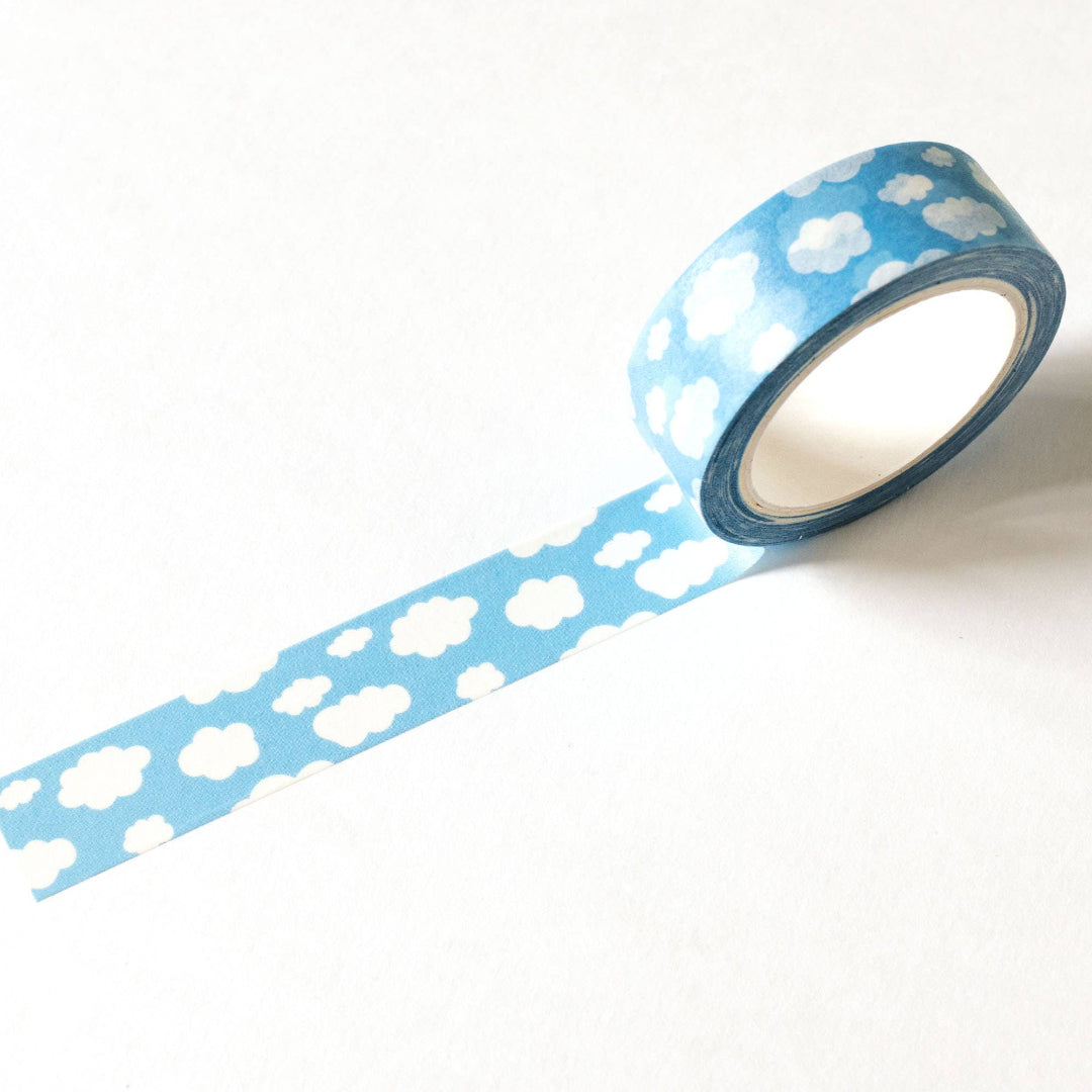Roll of blue tape with white cloud pattern on a white background