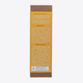 A cardboard box containing a Kiss Naturals Lava Lip Gloss Kit. The box is orange and white with the product name and a colorful illustration of a dragon. It states that the kit is 100% natural, made in Canada, and suitable for ages 6 and up.