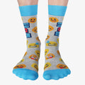 A pair of grey crew socks featuring a "Dad Jokes Loading..." graphic with a progress bar in red and blue, surrounded by various yellow and orange emoji faces. The text "DAD JOKES" is written in blue above the loading bar. The cuff, heel, and toe of the sock are light blue.