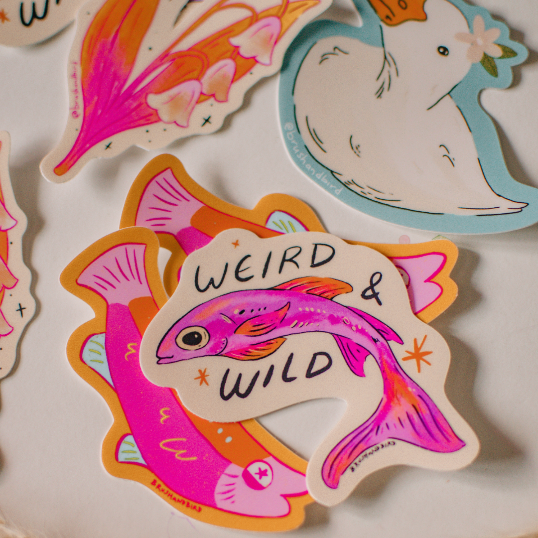 Colorful stickers with fish designs and text on a light background