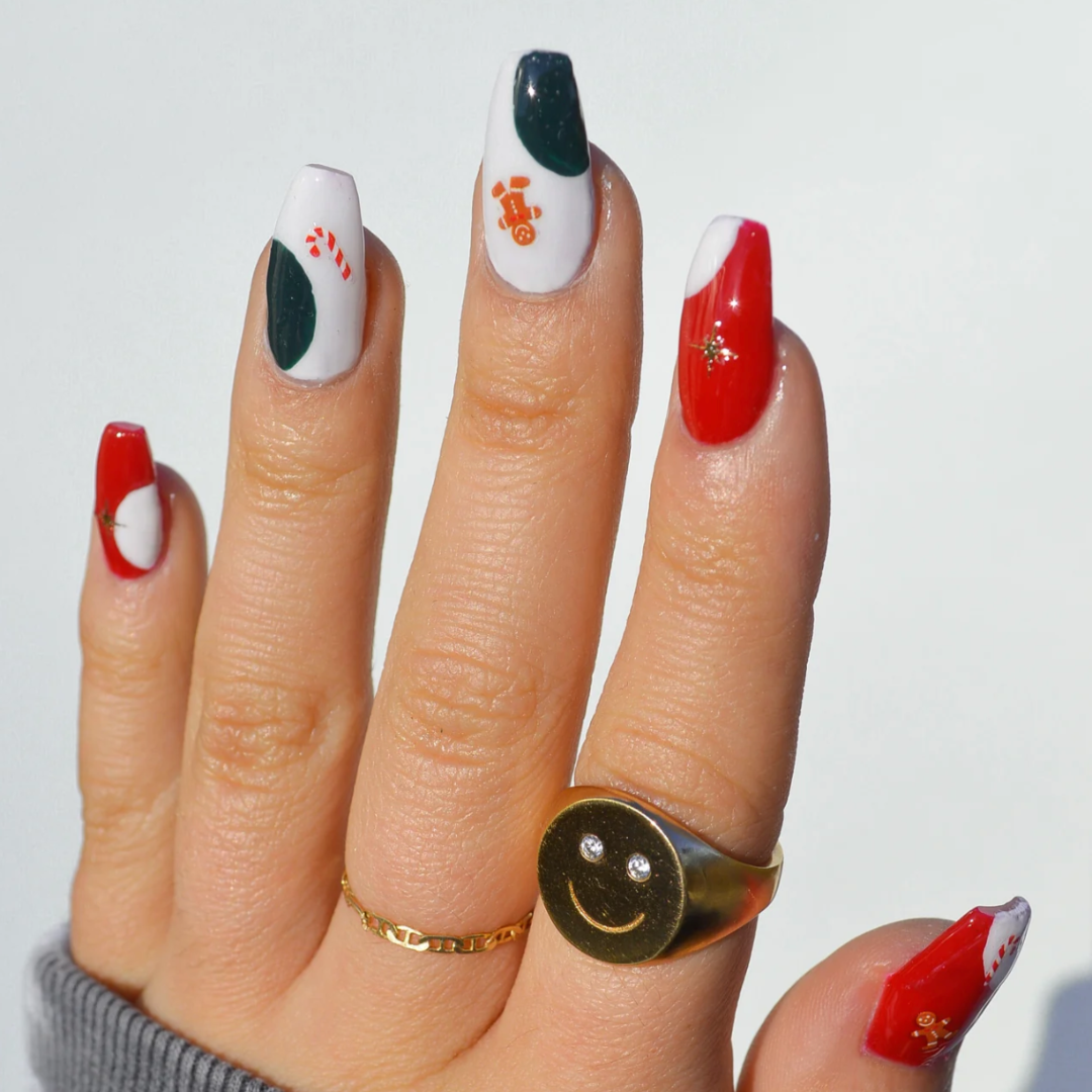 A sheet of Christmas-themed nail art stickers. The sheet is pink and has the brand name "Deco Beauty" printed on it. There's a section titled "Deco the Halls" and instructions on how to apply the stickers. The stickers include various Christmas-themed designs like snowflakes, bells, ornaments, and candy canes.