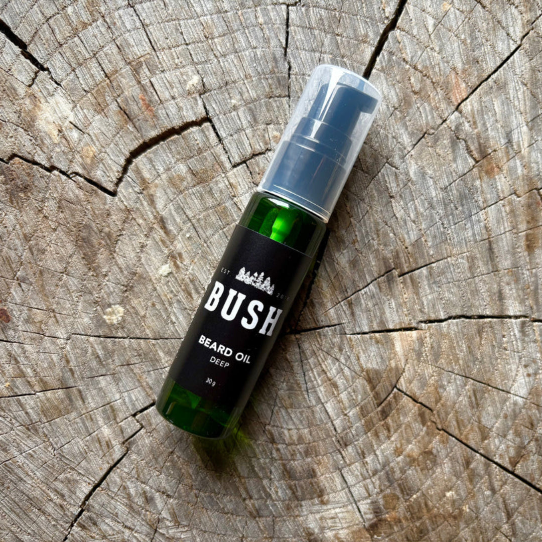Bottle of Bush beard oil on a wooden surface