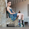 A pair of dark blue women's crew socks with a vibrant, abstract floral pattern in shades of orange, yellow, pink, fuchsia, green, and light blue. Text on one sock reads 