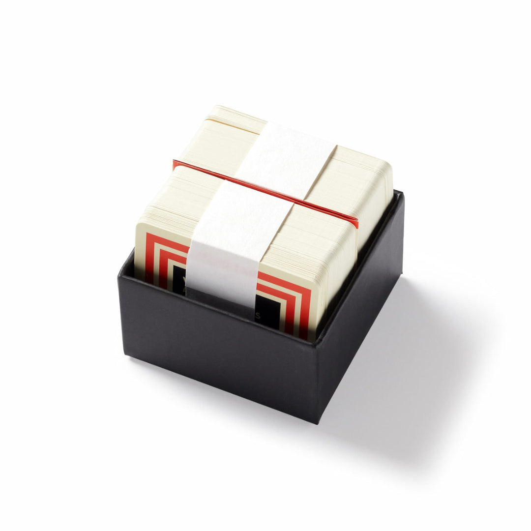 Stack of index cards with red stripes in a black holder on a white background