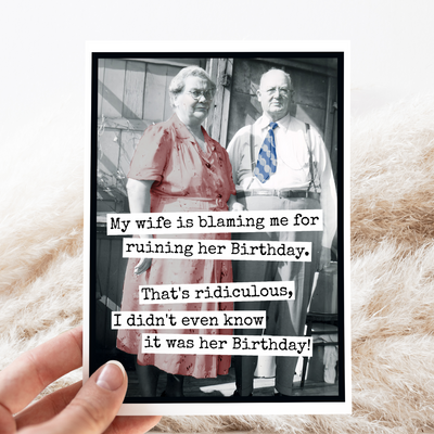 Black and white photo of an elderly couple with a humorous text overlay on a textured surface.