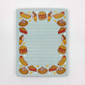 Notebook with food illustrations on a light blue background