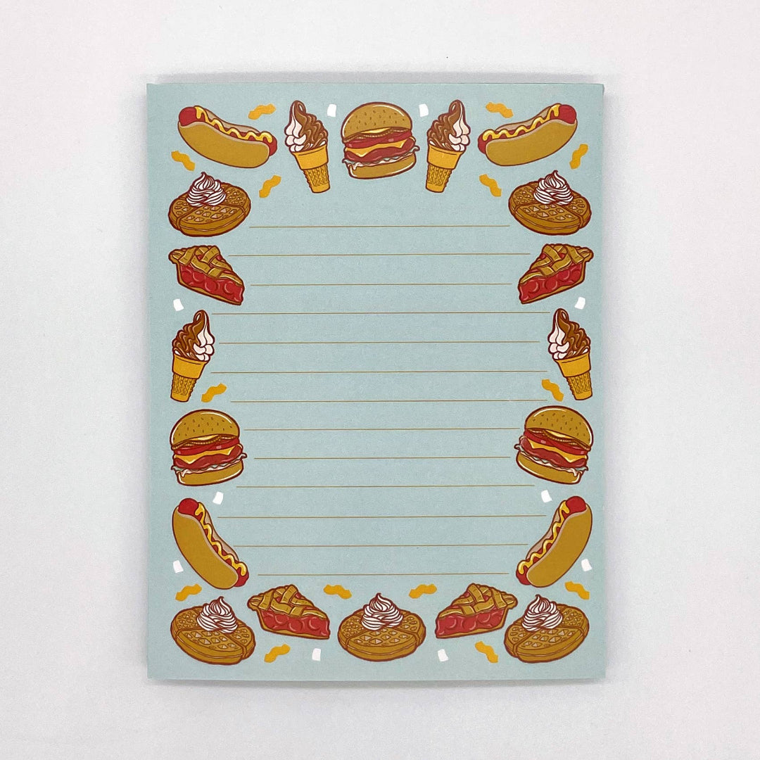 Notebook with food illustrations on a light blue background