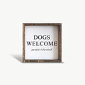 Framed sign with 'DOGS WELCOME people tolerated' text on a white background