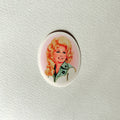 An oval-shaped pinback button featuring a vintage-style illustration of a smiling blonde woman with a green and white jacket, set against a textured off-white background.