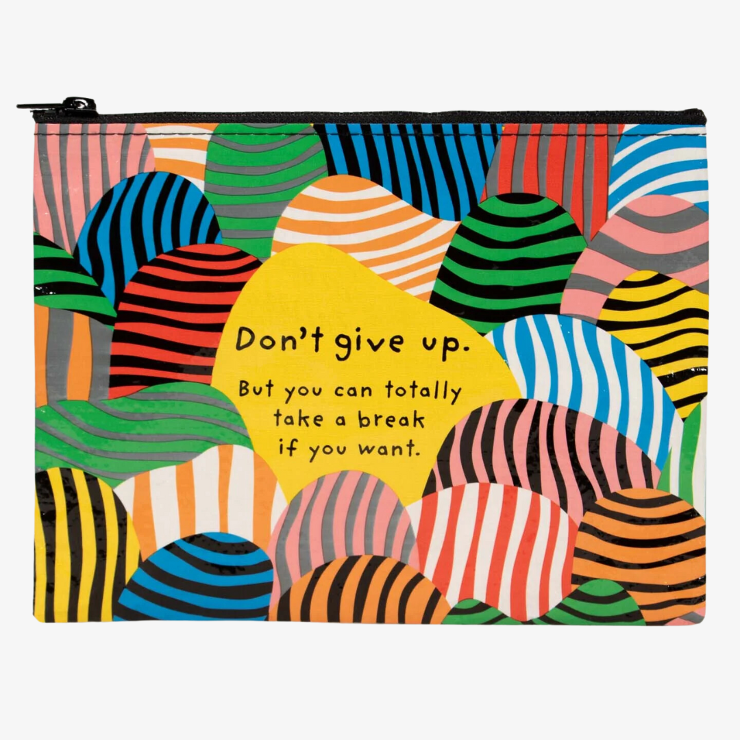 A zippered pouch with a playful design. The pouch has a bright yellow background with colorful, striped shapes resembling hills. The text "Don't give up. But you can totally take a break if you want." is printed in black at the bottom of the pouch.