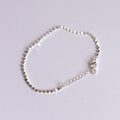 Silver bracelet on a light gray background