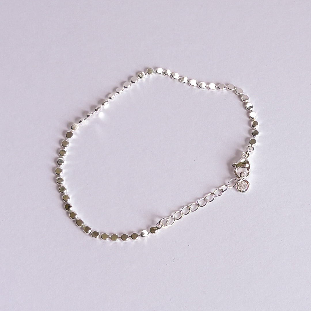 Silver bracelet on a light gray background