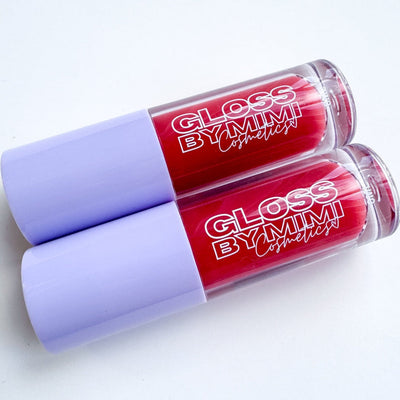 Two red lip glosses with purple caps on a white background, featuring 'Gloss by Mimi' branding.