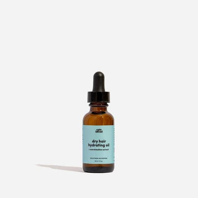 A small, amber glass dropper bottle of Epic Blend dry hair hydrating oil, featuring a light blue label with product details.