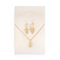 A gold necklace and earring set on a white card. The necklace features a gold leaf pendant, and the earrings are gold leaf-shaped drop earrings.
