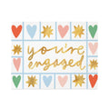 Card with 'you're engaged' text surrounded by colorful hearts and stars on a white background