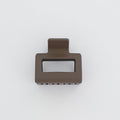 Bronze-colored metal clip on a white background
