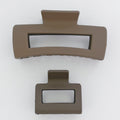Two brown hair clips on a white background