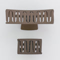 Two brown metal grates on a white background