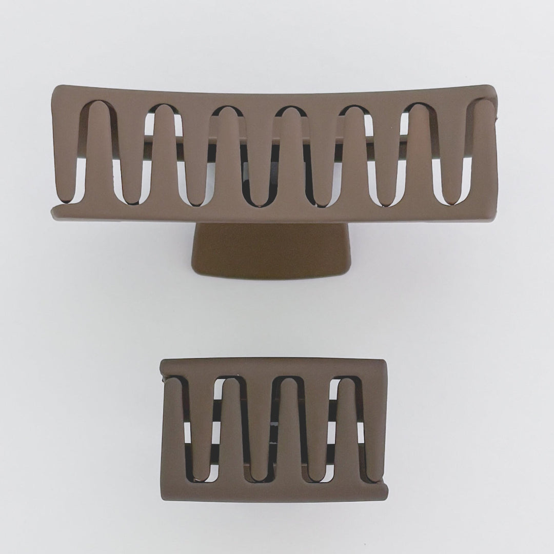 Two brown metal grates on a white background