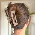 Close-up of a hair clip in a person's hair with a blurred background