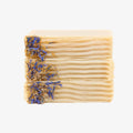 Two bars of soap with dried flowers on a white background