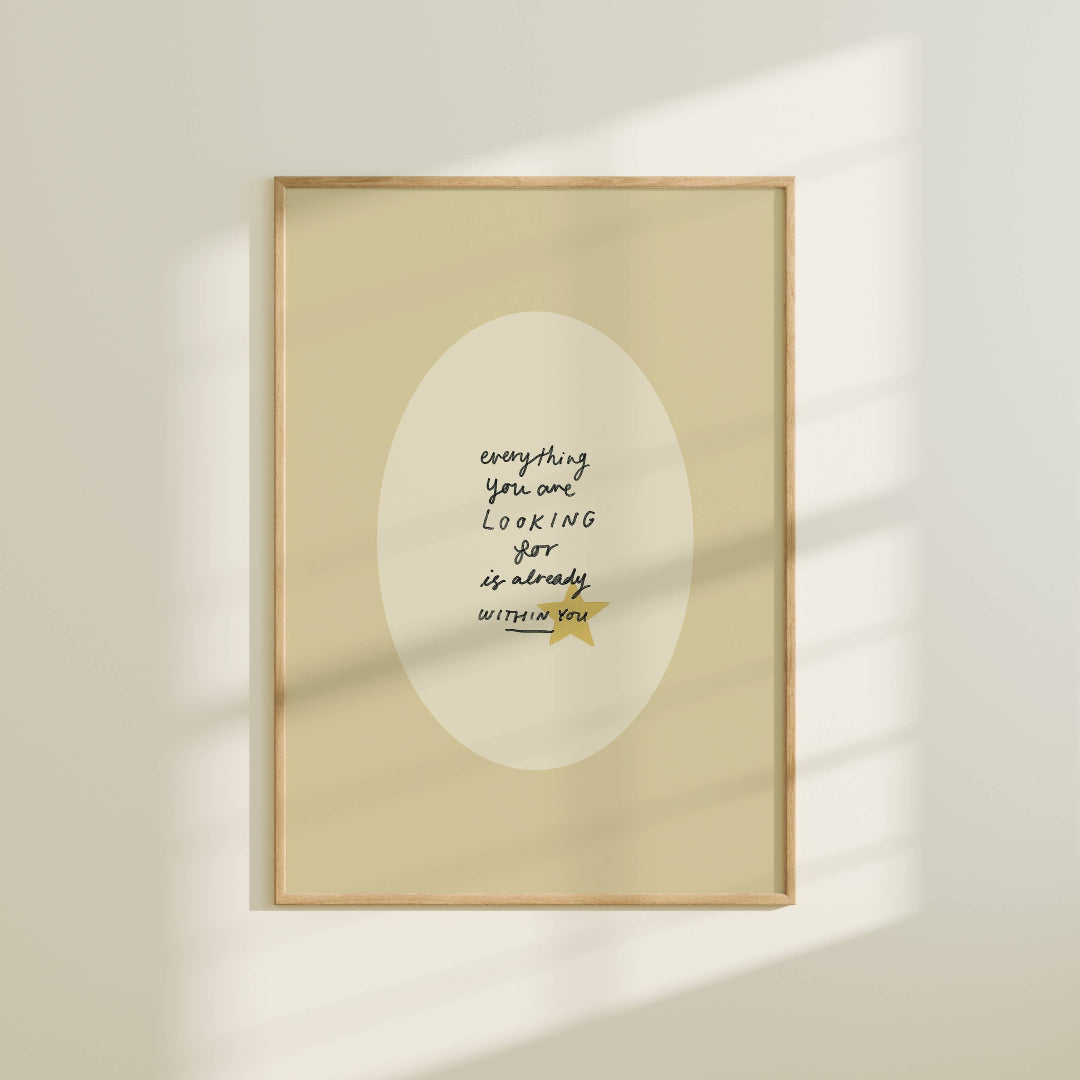 Framed artwork with motivational quote on a beige wall