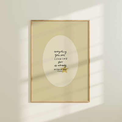Framed artwork with motivational quote on a beige wall