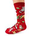 Red Christmas-themed socks with cat designs on a white background
