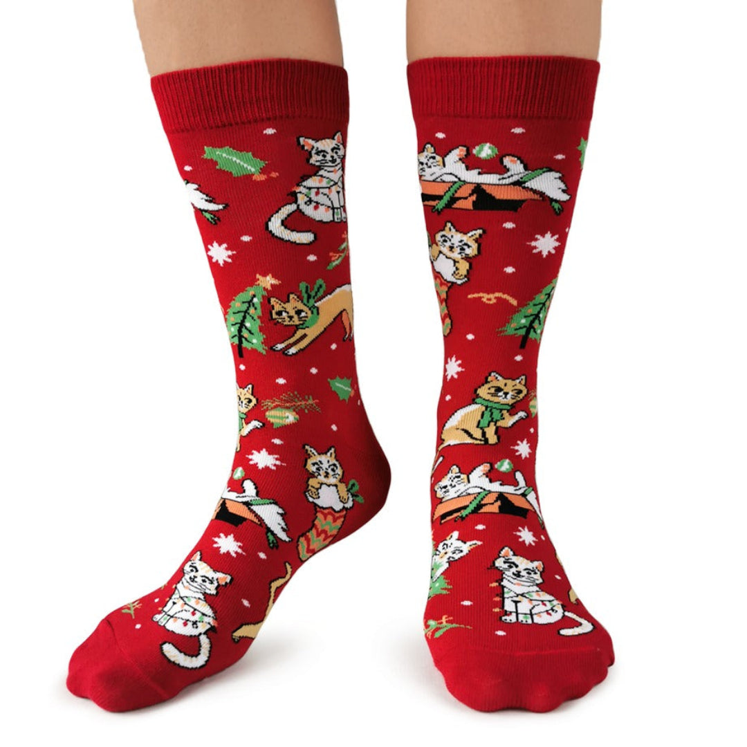 Red socks with cat illustrations on a white background