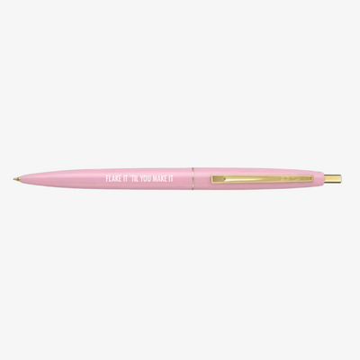 A light pink ballpoint pen with a gold clip. The barrel of the pen is inscribed with 