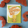 Father's Day card with trophy illustration on a blue background with decorative elements.