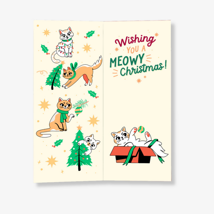 A pair of red socks with a festive cat design, packaged with a card. The socks feature cats playing with Christmas decorations, and the card has the text 