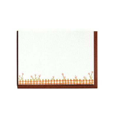 Framed artwork with a plaid pattern and floral elements on a white background