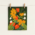 Floral artwork with orange, red, and white flowers on a dark green background, hanging on a string.