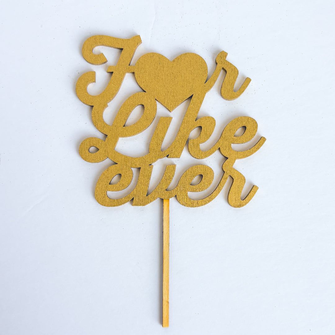 Gold cake topper with 'I love you' text on a white background